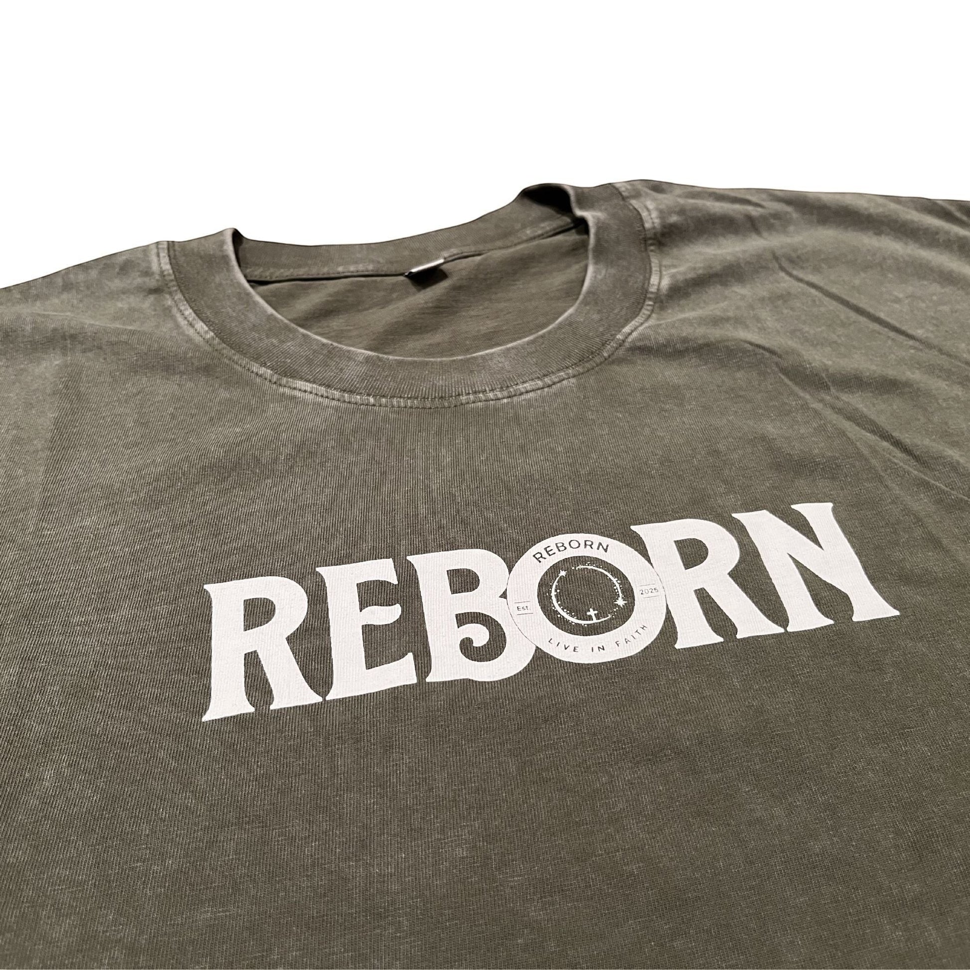 Live In Faith REBORN faded olive green cotton t-shirt with white text logo on chest.